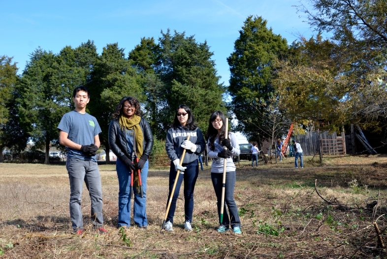 Students in a field doing community service