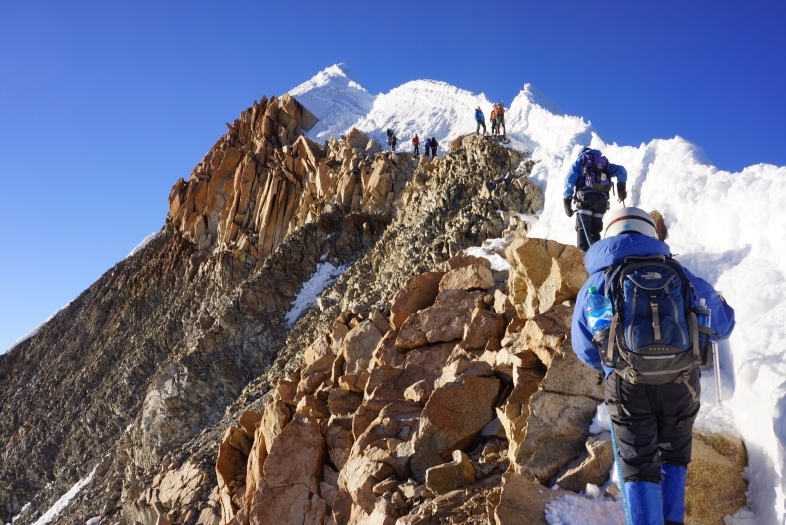 People climb mountain in Bolivia that is covered in ice