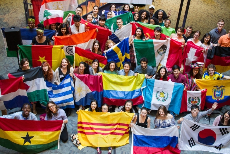 Students hold flags from many different countries