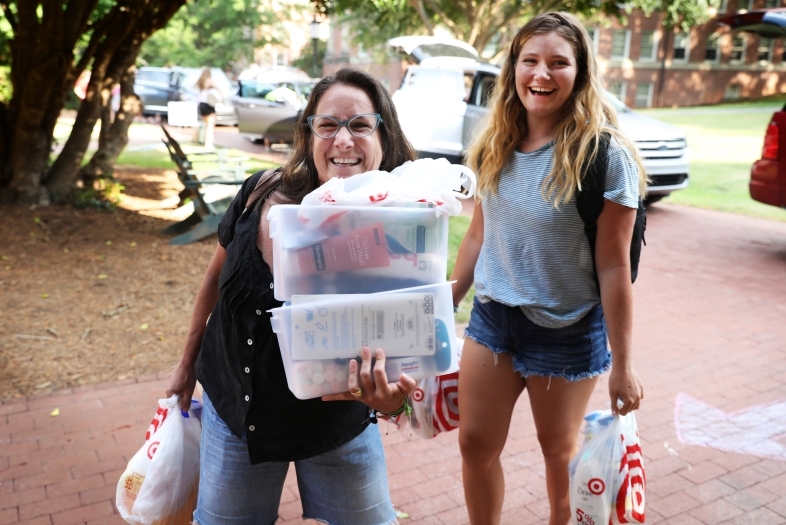 Student and her family member unload the car