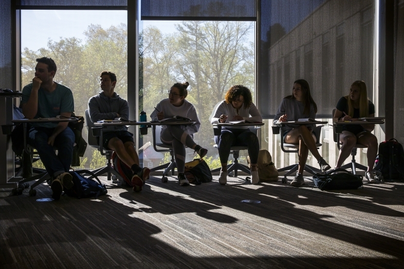 Wall Center Students sitting at desks in class with window behind