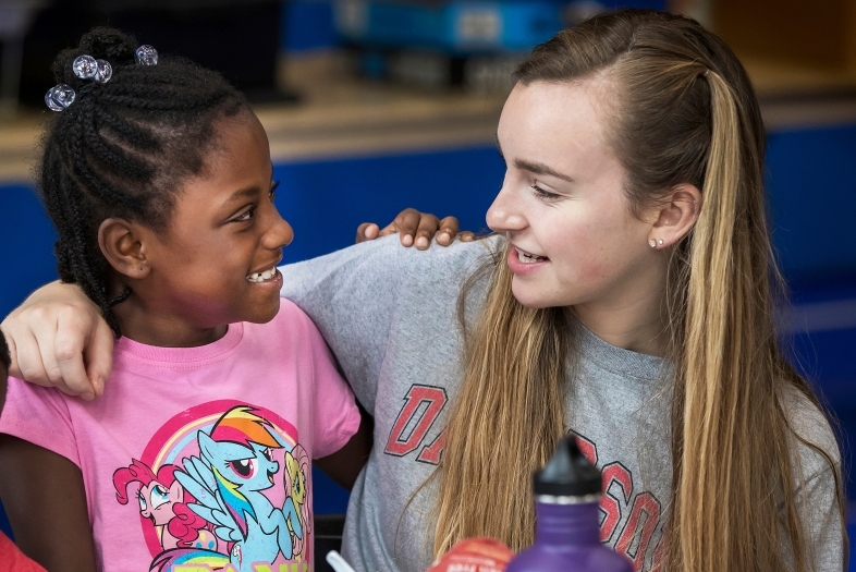 Davidson Student and Freedom School Student smile at each other