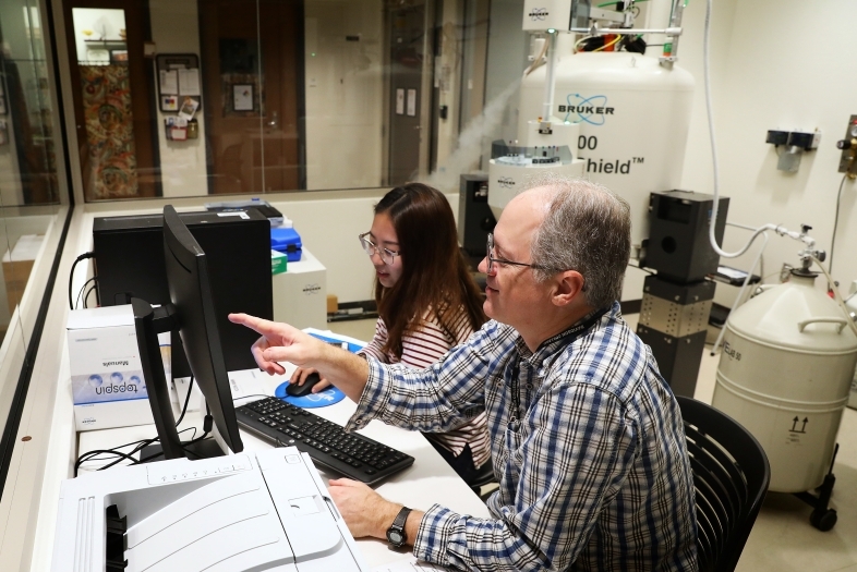 Prof. Blauch and Student working with large chemistry equipment