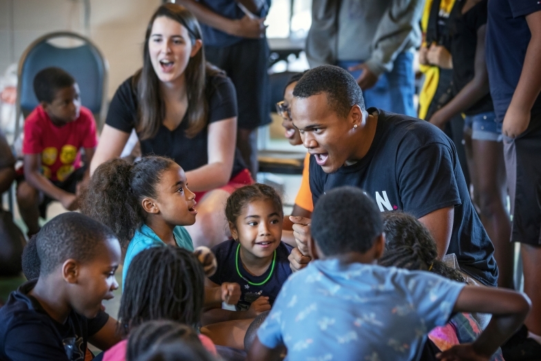 Students lead singing with kids from Freedom Schools