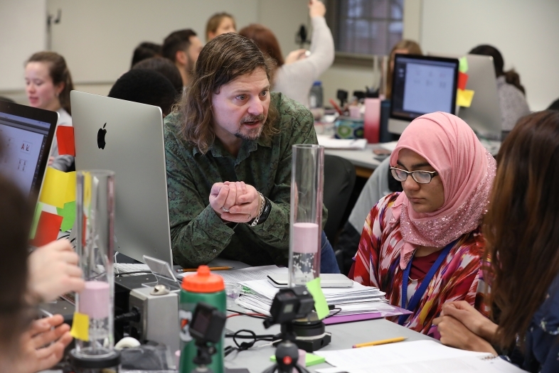 Prof. Belloni and Hana Kamran chat in class