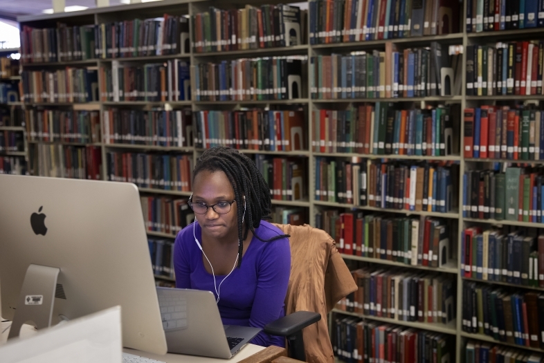 Student Working on Lab Computer and Laptop