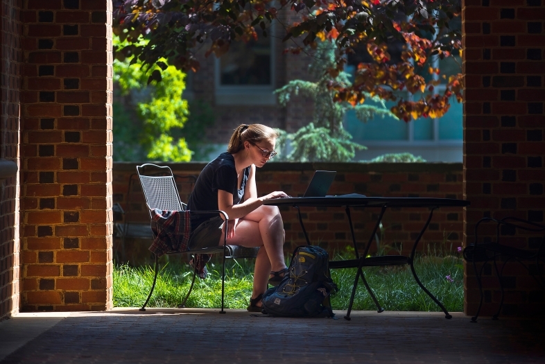 Student on Laptop Outside Library