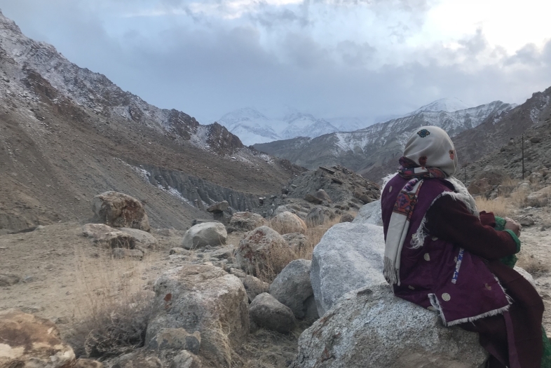 Scarfed lady looking towards mountains of South Asia