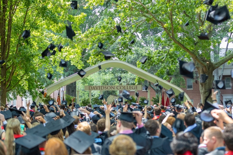 Davidson College Commencement Carol in the background as students throw up their caps