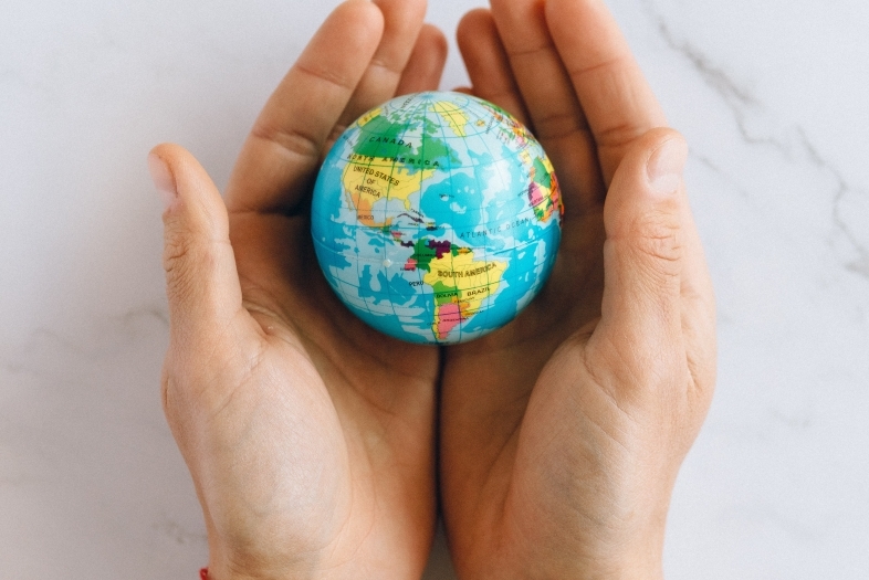 Hands holding globe