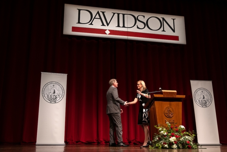 Doug Hicks and Alison Mauzé on stage with Davidson signs