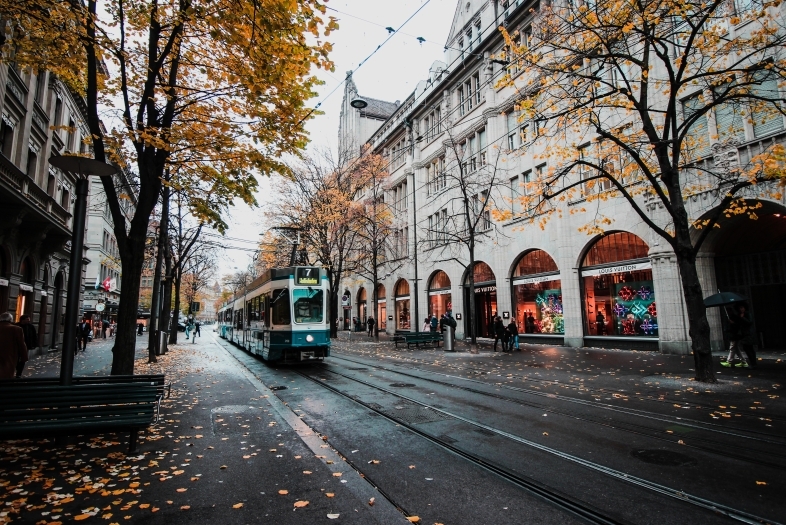 Stock photo of city with train and foliage