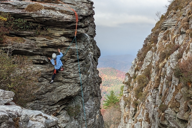 Student climbing mountain