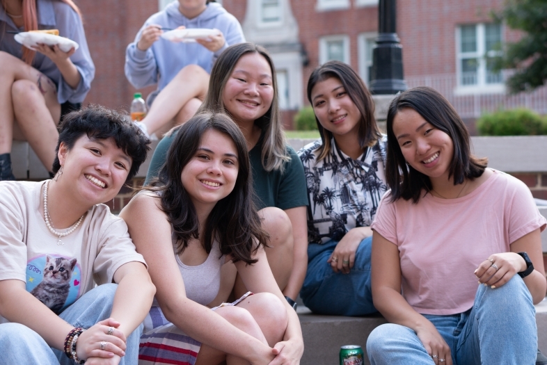 students smiling sitting on steps