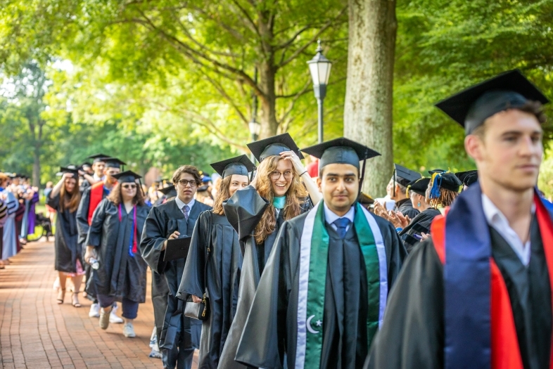 procession of students in caps and gowns