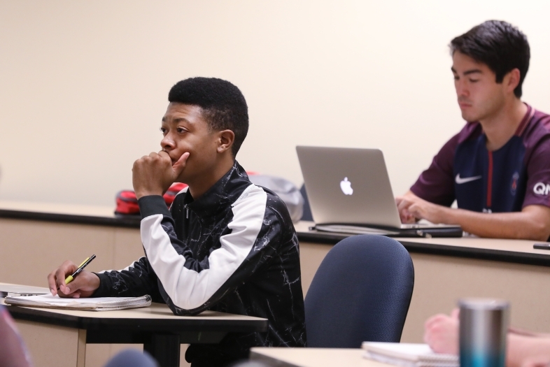 Students take notes in a political science class