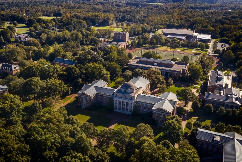 Aerial view of campus with one large building in the center