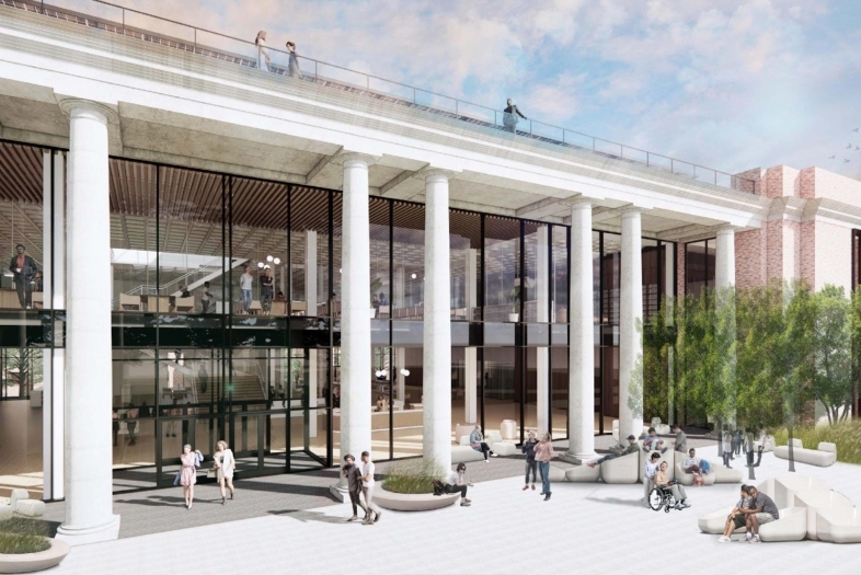 a modern looking library with white columns and green trees