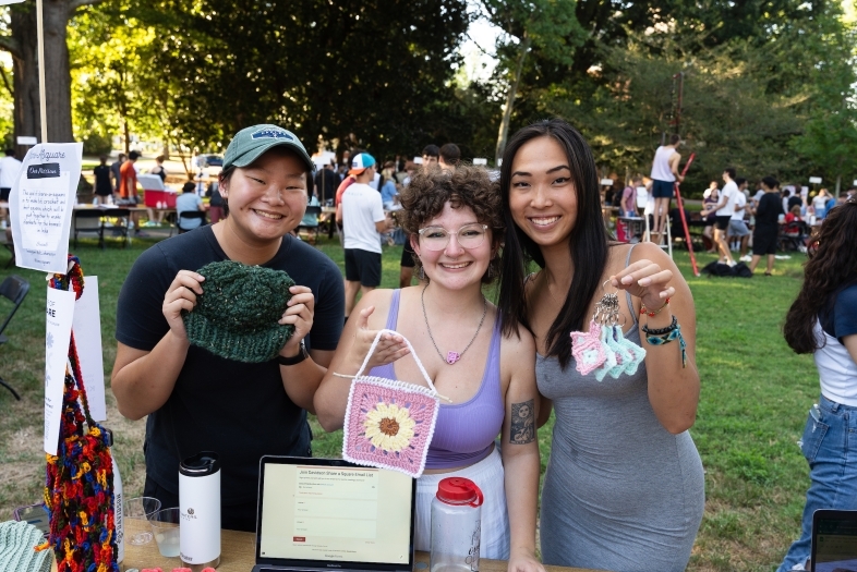 Students holding crafts at activities fair