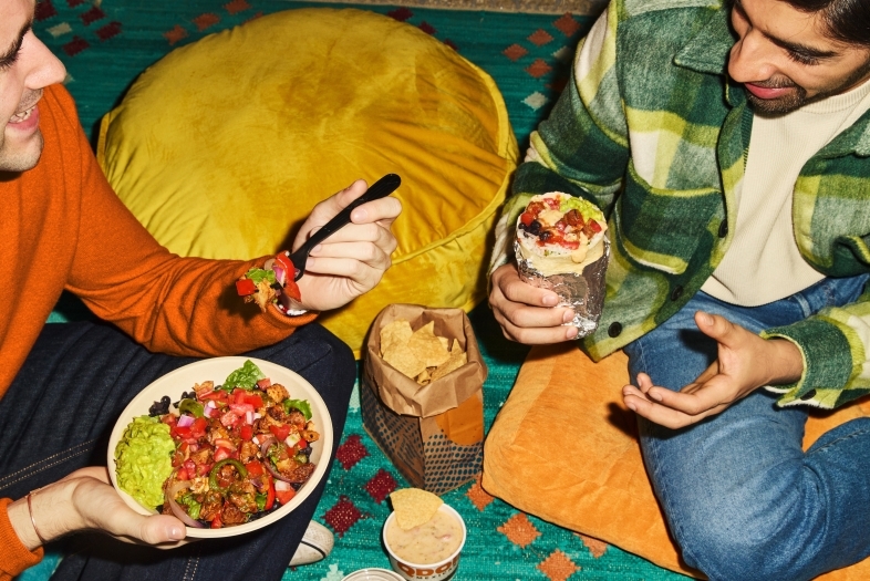 Qdoba Students eating together sitting on the floor