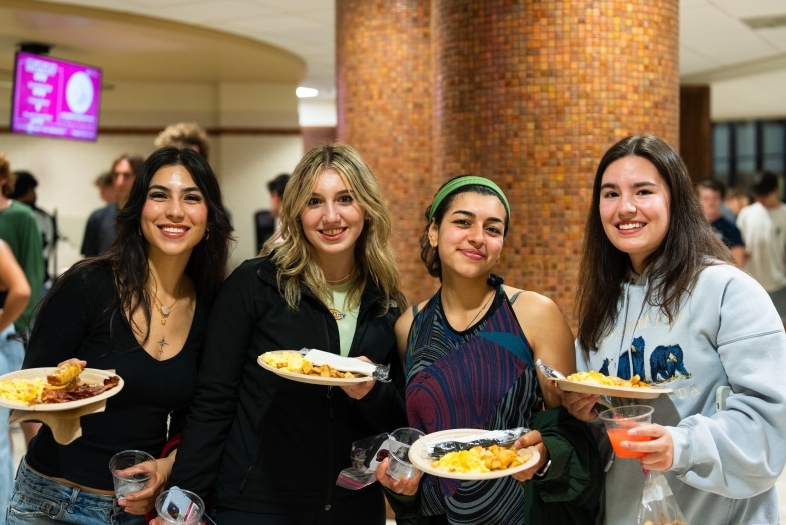 four students at the Night Owl Breakfast at Commons