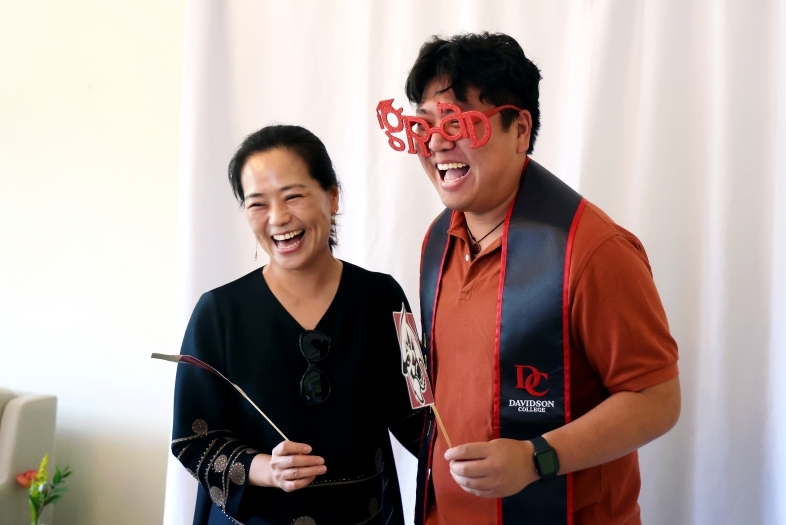 a young man with his mom smiling