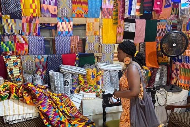 Kasha Salia looing at fabrics in a Market during the Davidson in Ghana program