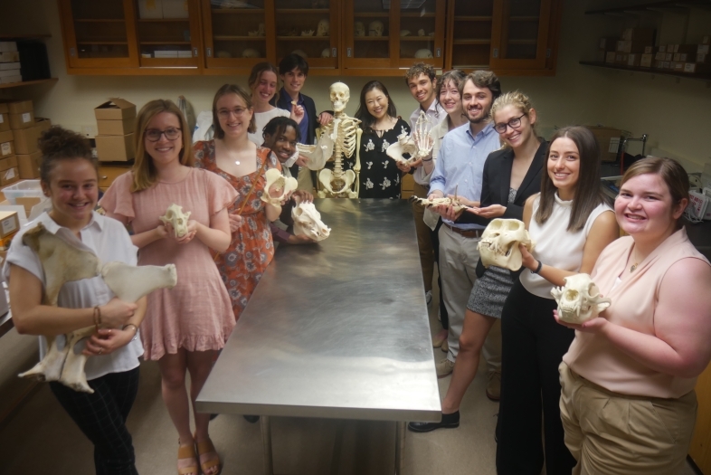 Helen Cho in class with students holding bones