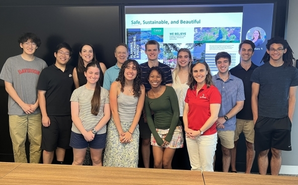 a group of students and adults together in a conference room