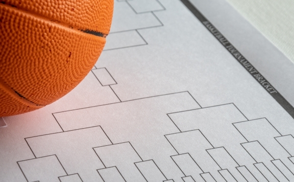 a basketball bracket on a piece of paper with a basketball next to it