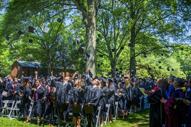 Graduates of the Class of 2019 throw their caps in the air