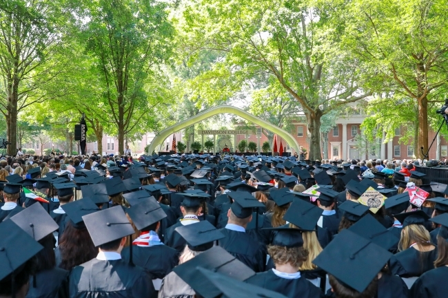 Class Caps lined up with stage in the background