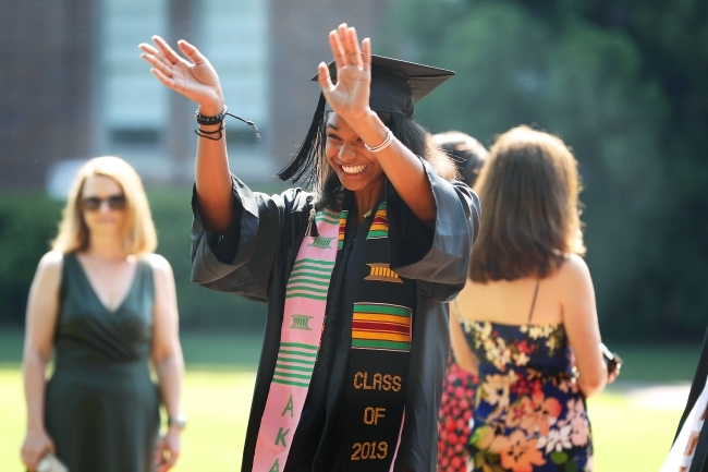 Student Waves at Camera