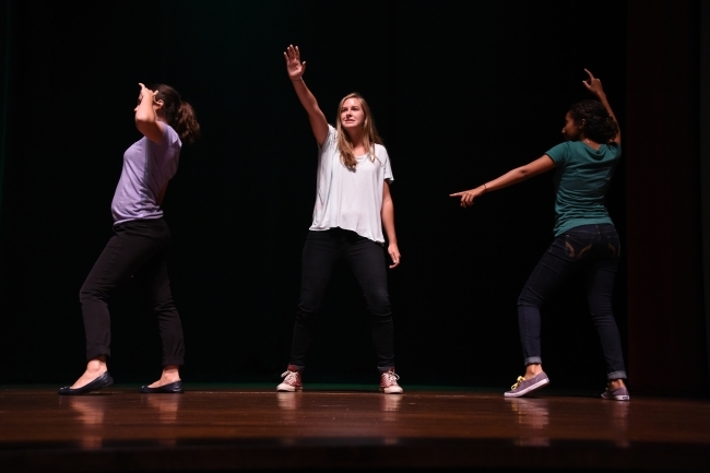 Health advisers dancing on stage as part of a skit