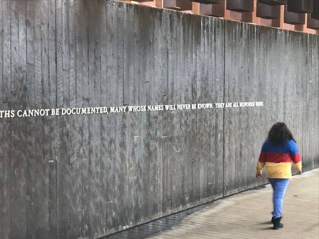 Student walks along memorial