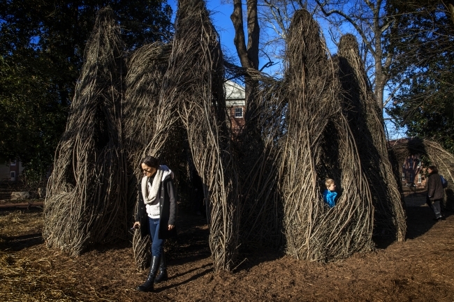 Patrick Dougherty Sculpture with visitor