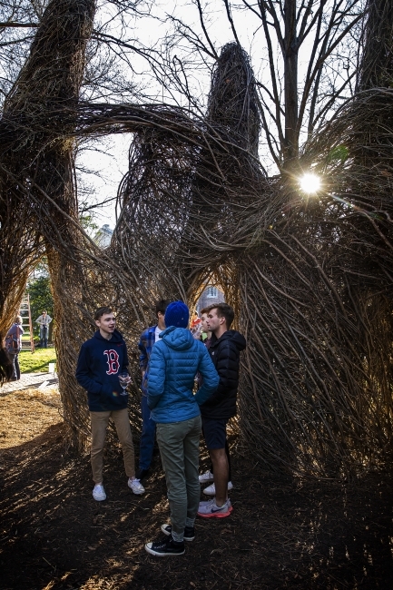 Patrick Dougherty Sculpture with students at sunset