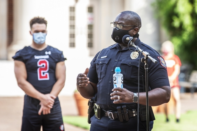 Social Justice Event - campus police officer speaking in front of Chambers