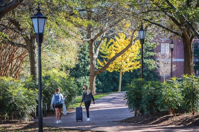 Students in Masks with Suitcase Move Out