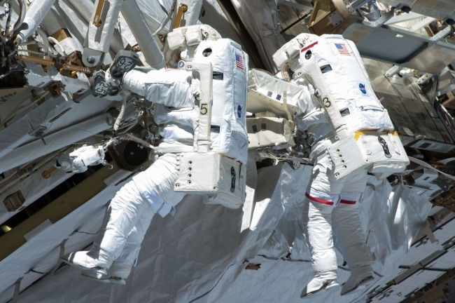 Chris Cassidy (right) and Tom Marshburn Fixing a pump controller box leaking ammonia coolant on the International Space Station