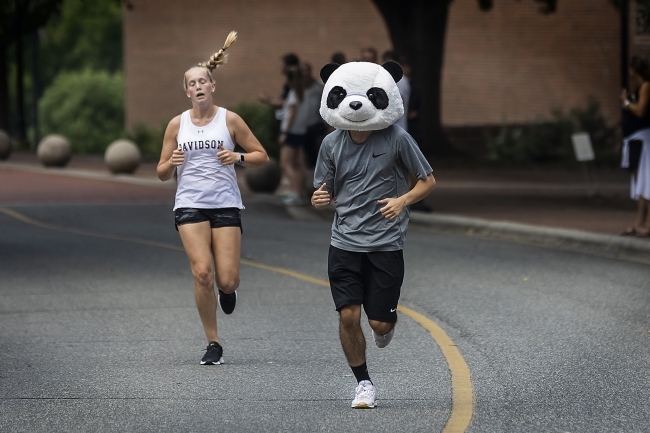 Students Race at Cake Race, one with Panda mask on