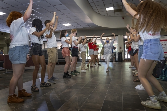 Orientation Welcome Tunnel with Family Member Walking Through and Students Cheering