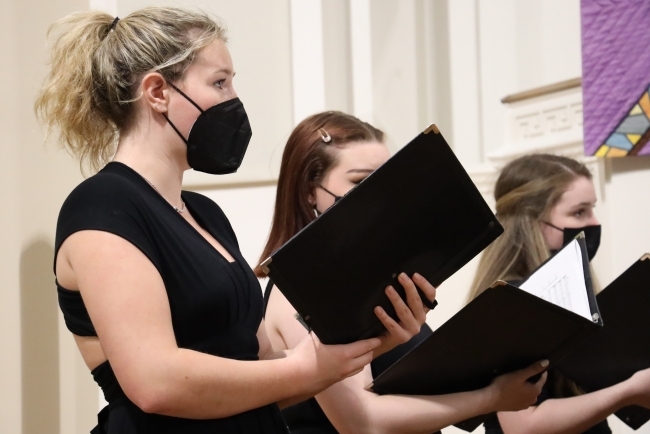 Davidson Chorale singing and holding books