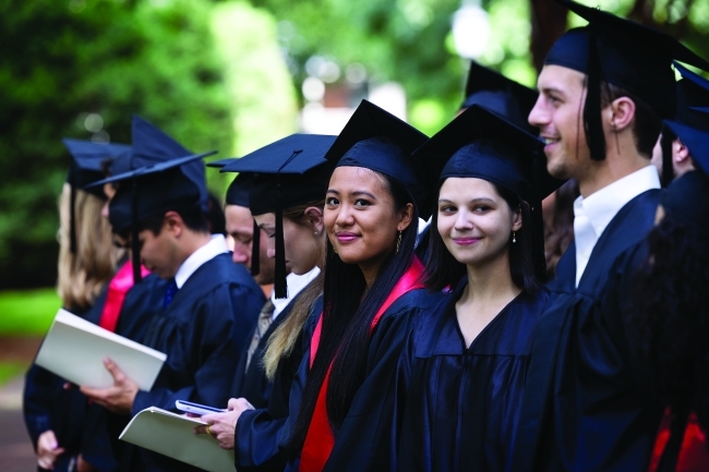 Class of 2020 students line up at their Commencement in 2022