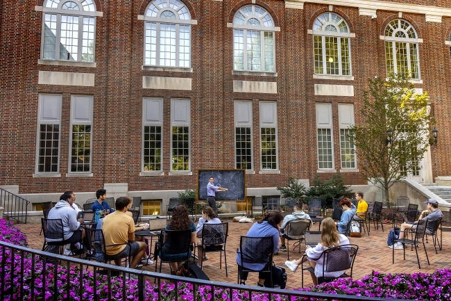 class being taught outdoors by Wall Academic Building