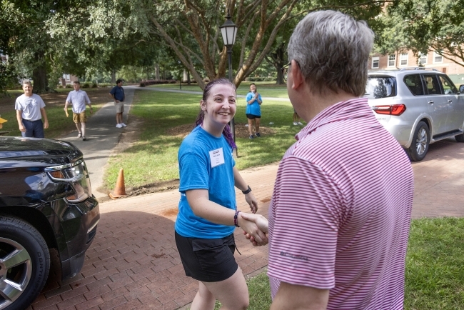 Move In Day 2022 Doug Hicks shaking a student's hand