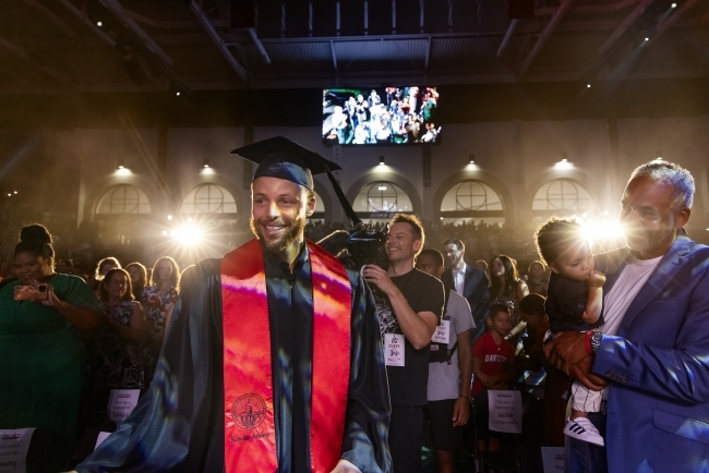 Stephen Curry walking into Belk Arena for his commencement