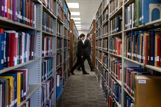 Koji Tomita walking through library