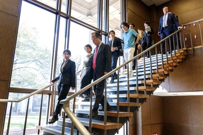 Koji Tomita '77 walking through the library