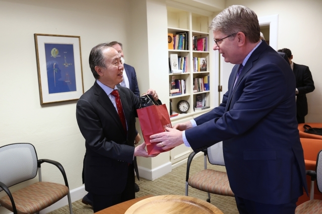 President Doug Hicks giving gift to Koji Tomita